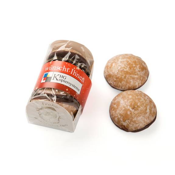 Lebkuchen mit Glasur als Werbemittel in transparenter Banderole und Logo „KHG Kopiersysteme“, daneben zwei einzelne Lebkuchen.