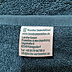 Nahaufnahme des Weblabels mit Kundenlogo, sowie der Herstellerinformationen. Anbringung auf Sonderproduktion Badehandtuch mit Logo.