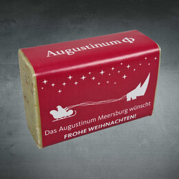 Logo-Seife mit bedruckter farbiger Papierbanderole als Weihnachtsgeschnek für Altenheim und Pflegedienste